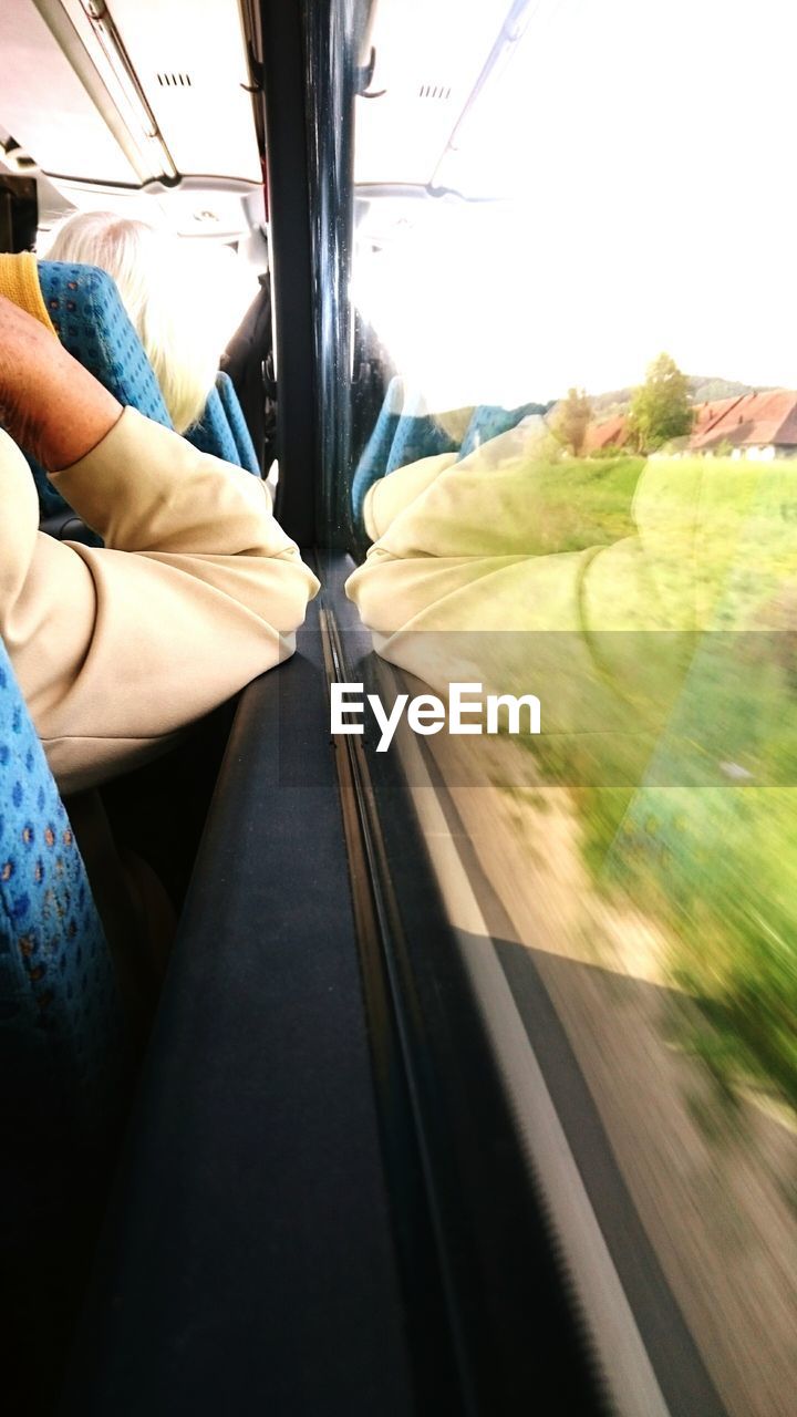 Cropped image of man traveling in bus