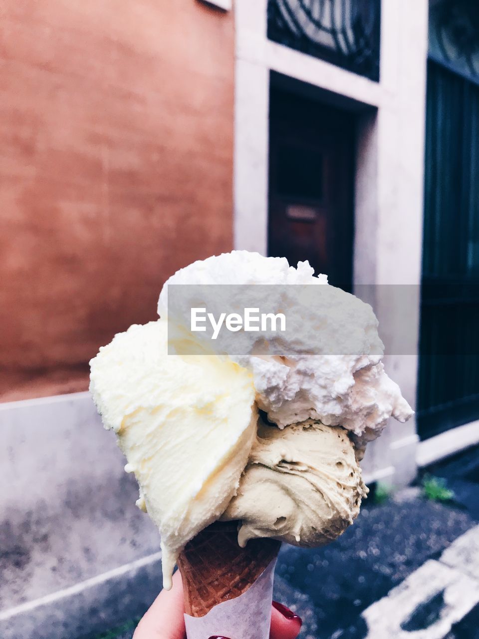 Cropped hand of woman holding ice cream cone