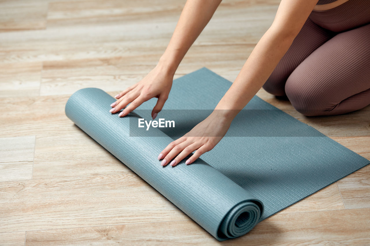 adult, one person, women, indoors, human leg, limb, lifestyles, young adult, arm, flooring, wood, hardwood floor, relaxation, human limb, wellbeing, female, hand, exercising, home interior, physical fitness, yoga, sports, exercise mat, barefoot