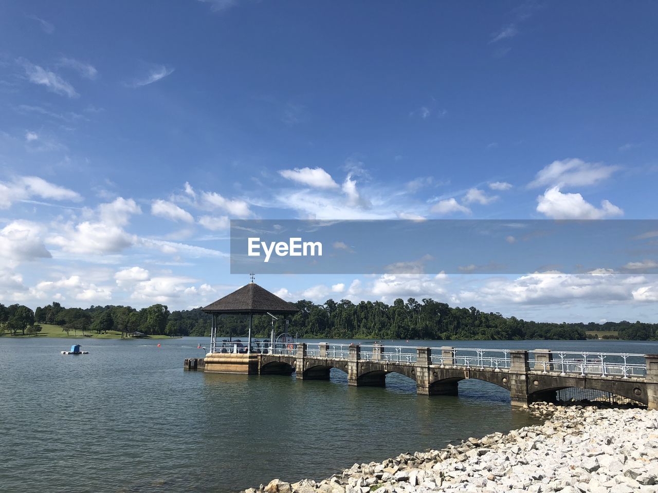 water, sky, architecture, shore, built structure, sea, cloud, nature, body of water, building exterior, scenics - nature, bay, travel destinations, beauty in nature, building, tranquility, pier, travel, no people, beach, blue, land, house, vacation, reservoir, tranquil scene, coast, stilt house, horizon, day, outdoors, tourism, ocean, landscape, hut, transportation, environment, trip, nautical vessel, holiday, idyllic, reflection, jetty, tree