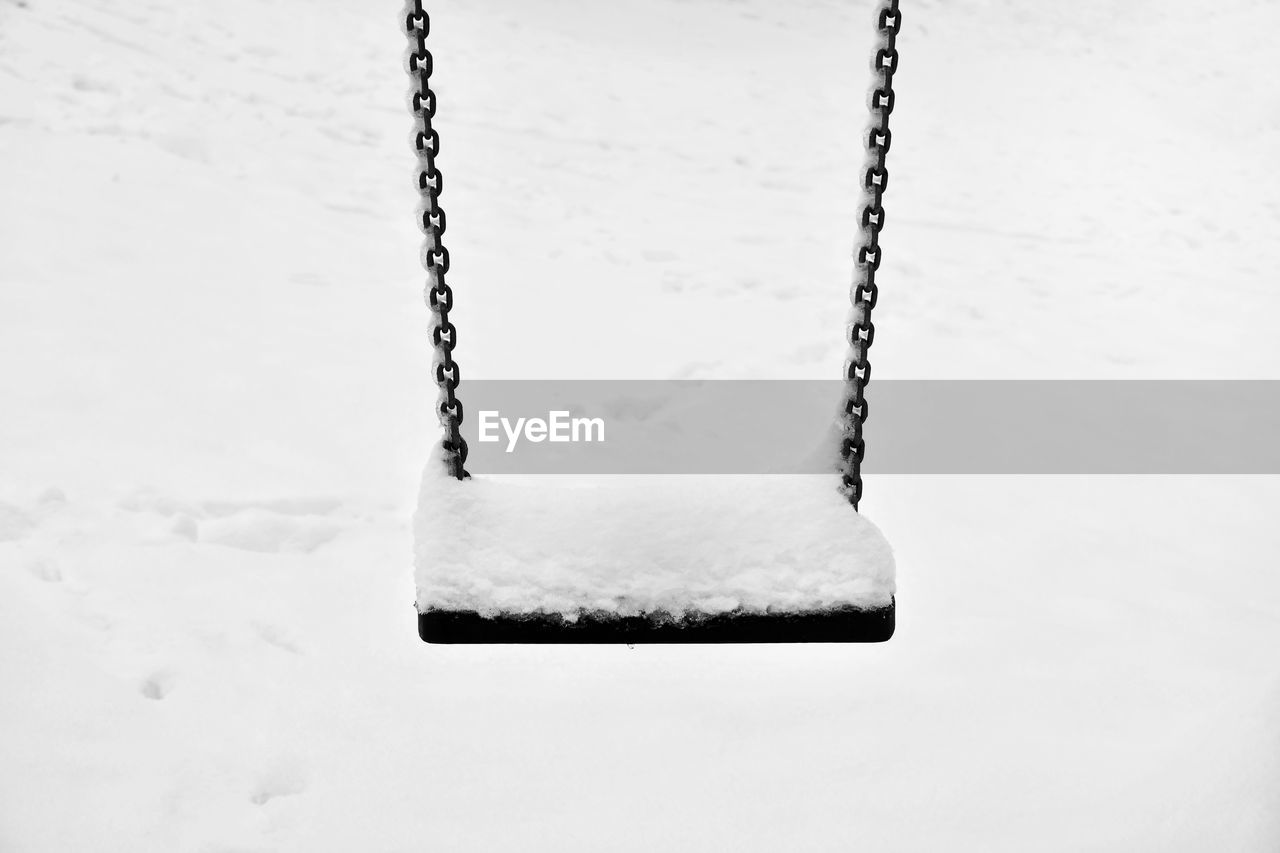 Close-up of snow on swing