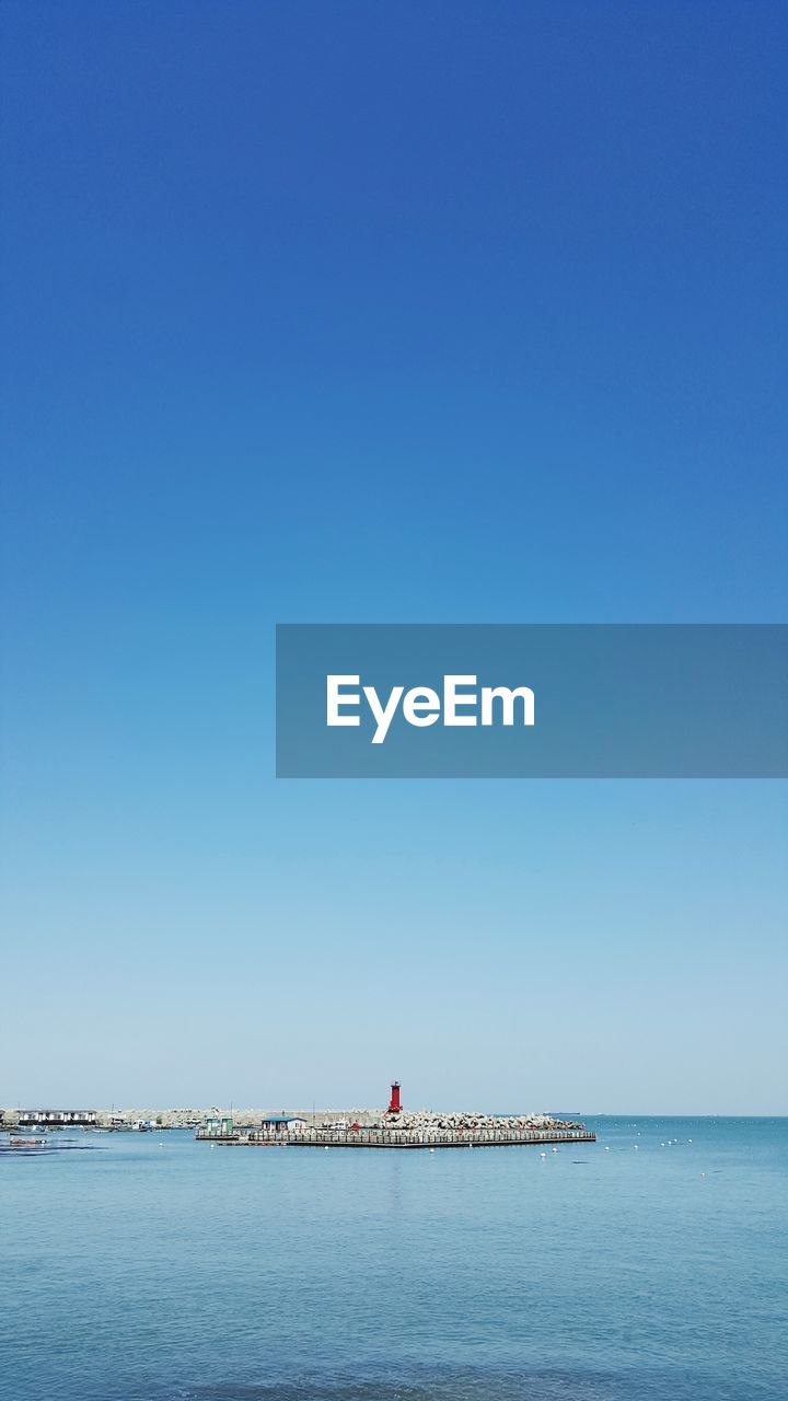 Distant view of lighthouse at sea