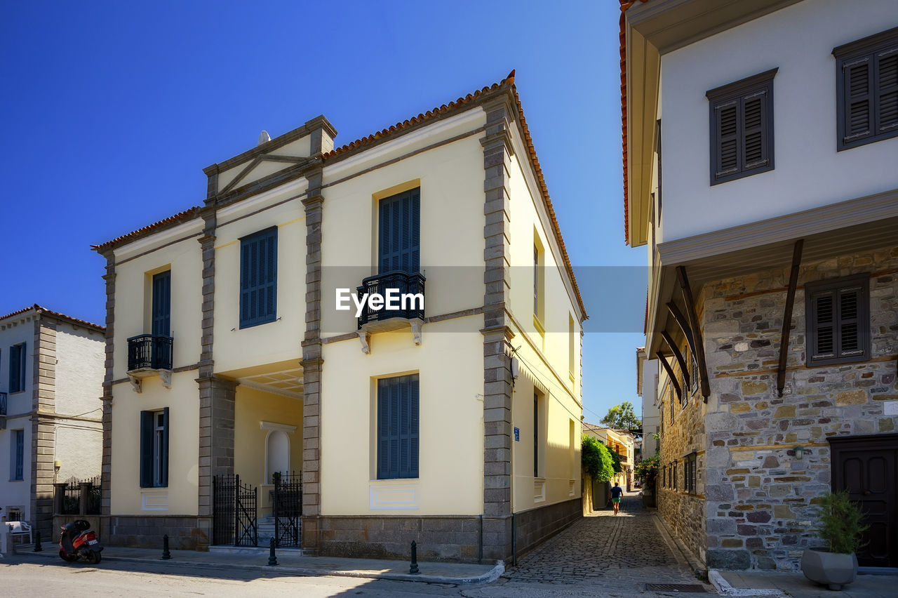 Low angle view of buildings against blue sky