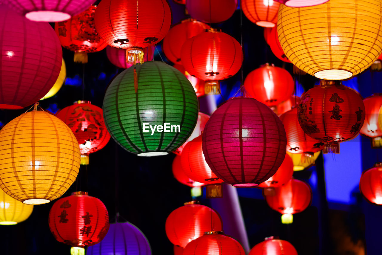 Low angle view of illuminated lanterns hanging at night