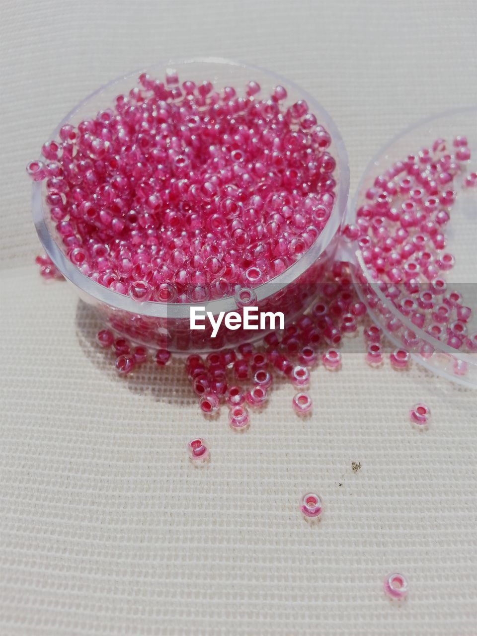 High angle view of pink pearls in container