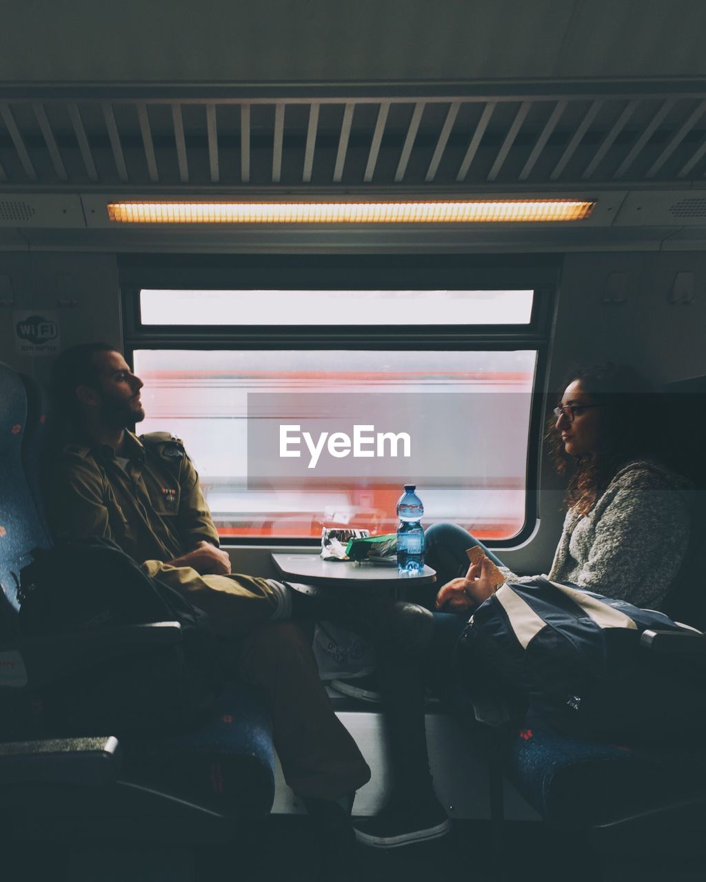 WOMAN SITTING IN TRAIN