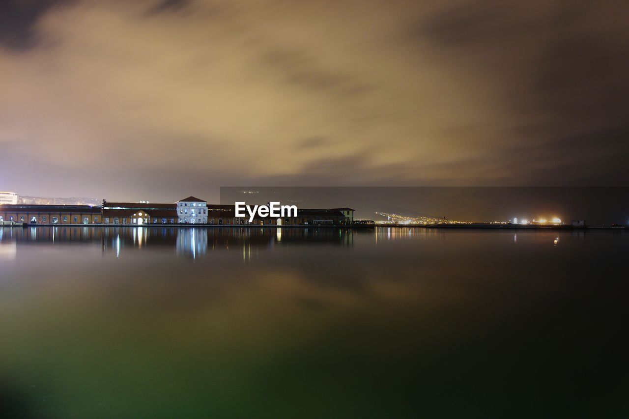 ILLUMINATED SEA AGAINST SKY AT NIGHT