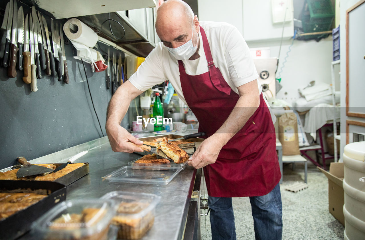 Baker wearing a mask and serving balkan food in belgrade,serbia