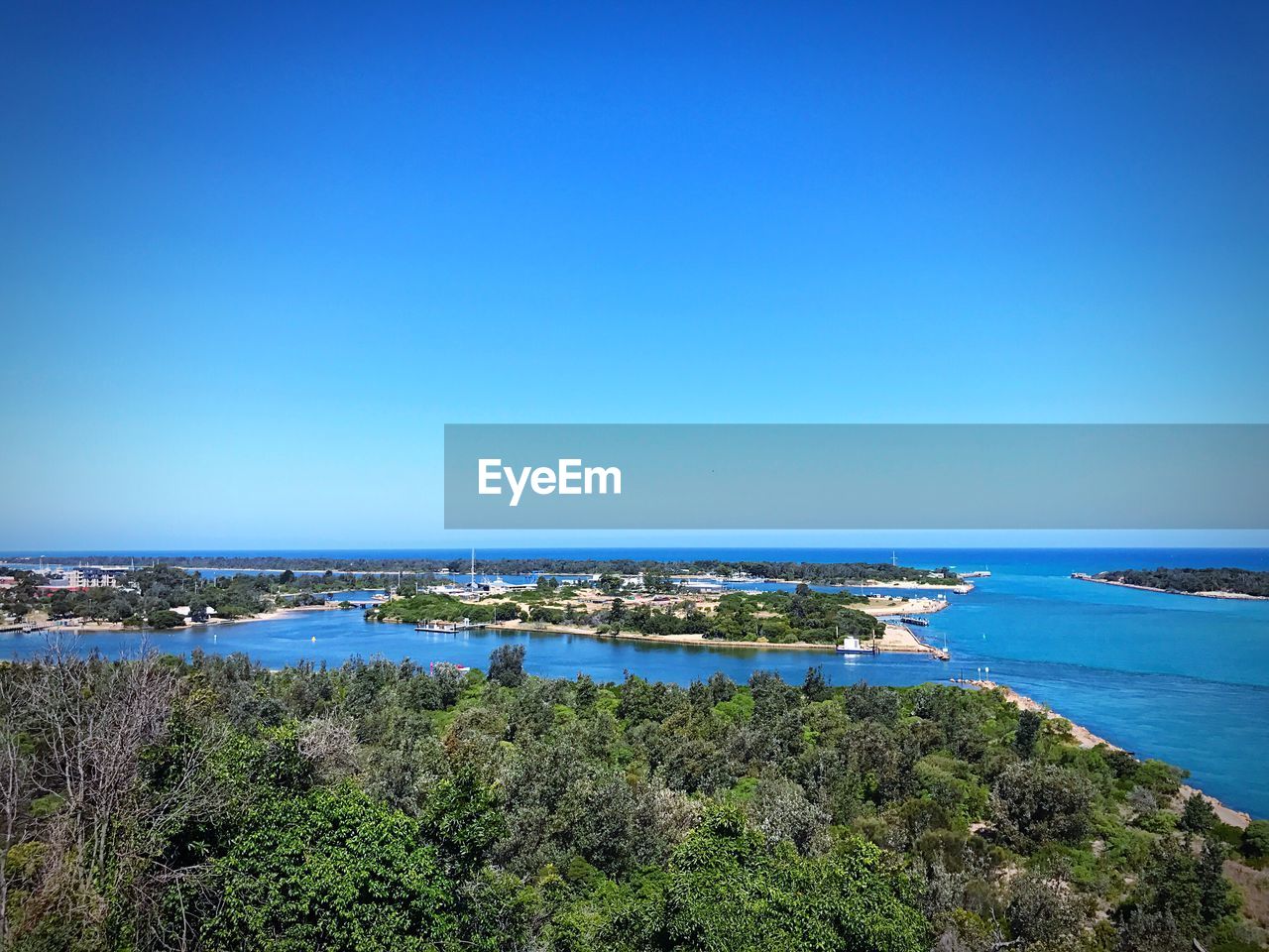 PANORAMIC SHOT OF SEA AGAINST CLEAR BLUE SKY