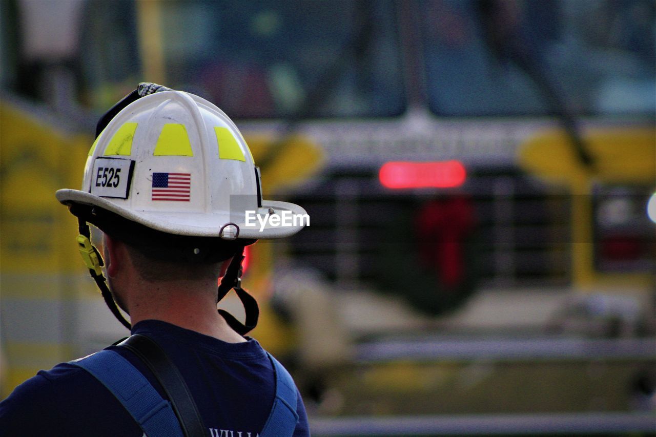 Rear view of man wearing hardhat outdoors