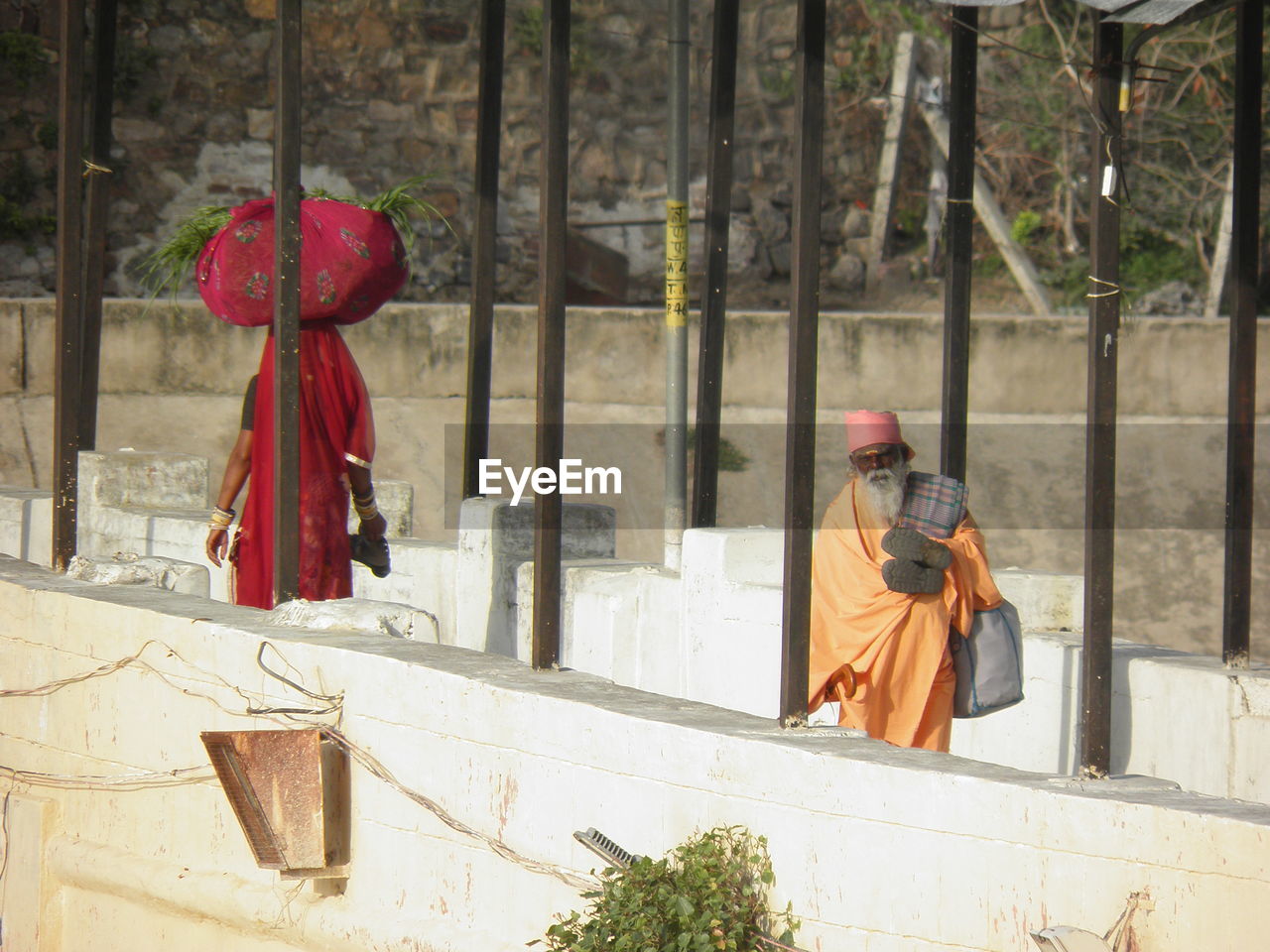 REAR VIEW OF MAN WITH CROSS ON TREE