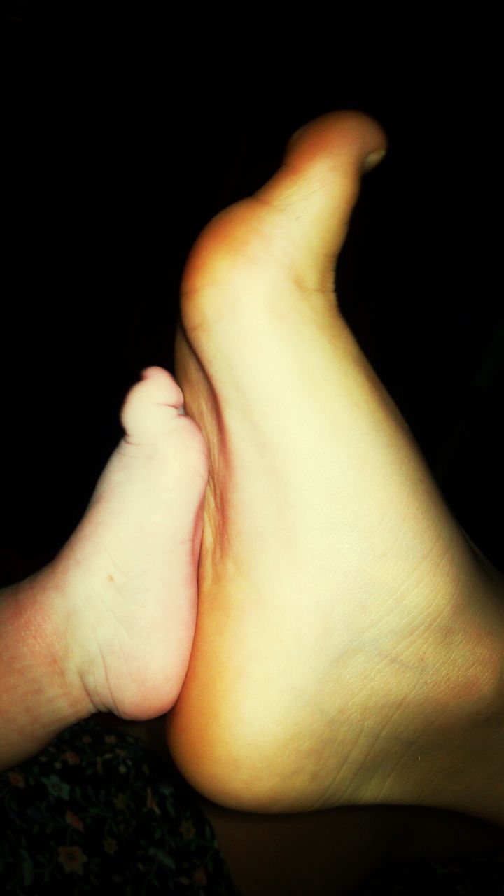 Extreme close up of adult and baby legs
