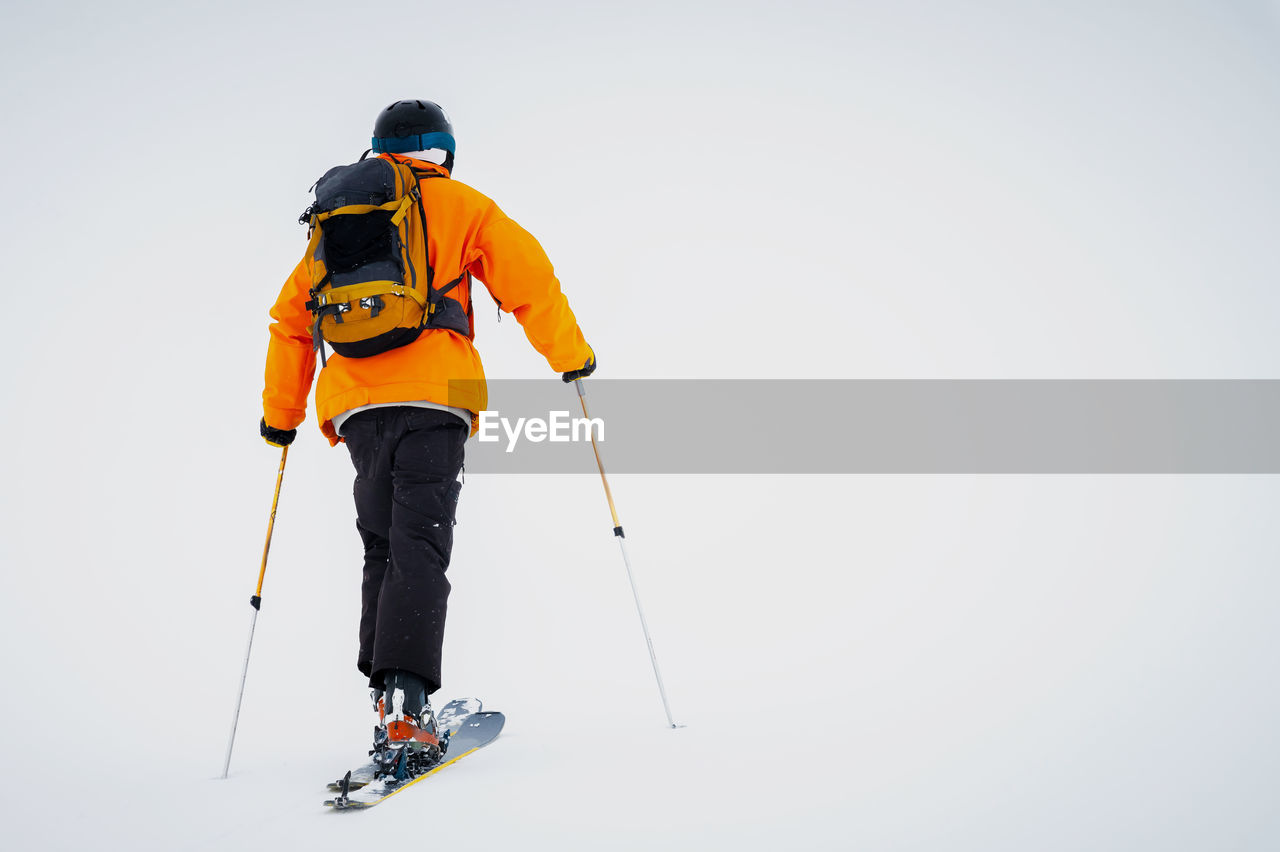 Ski tourist goes uphill. snow and winter sports, ski touring in the mountains, entertainment