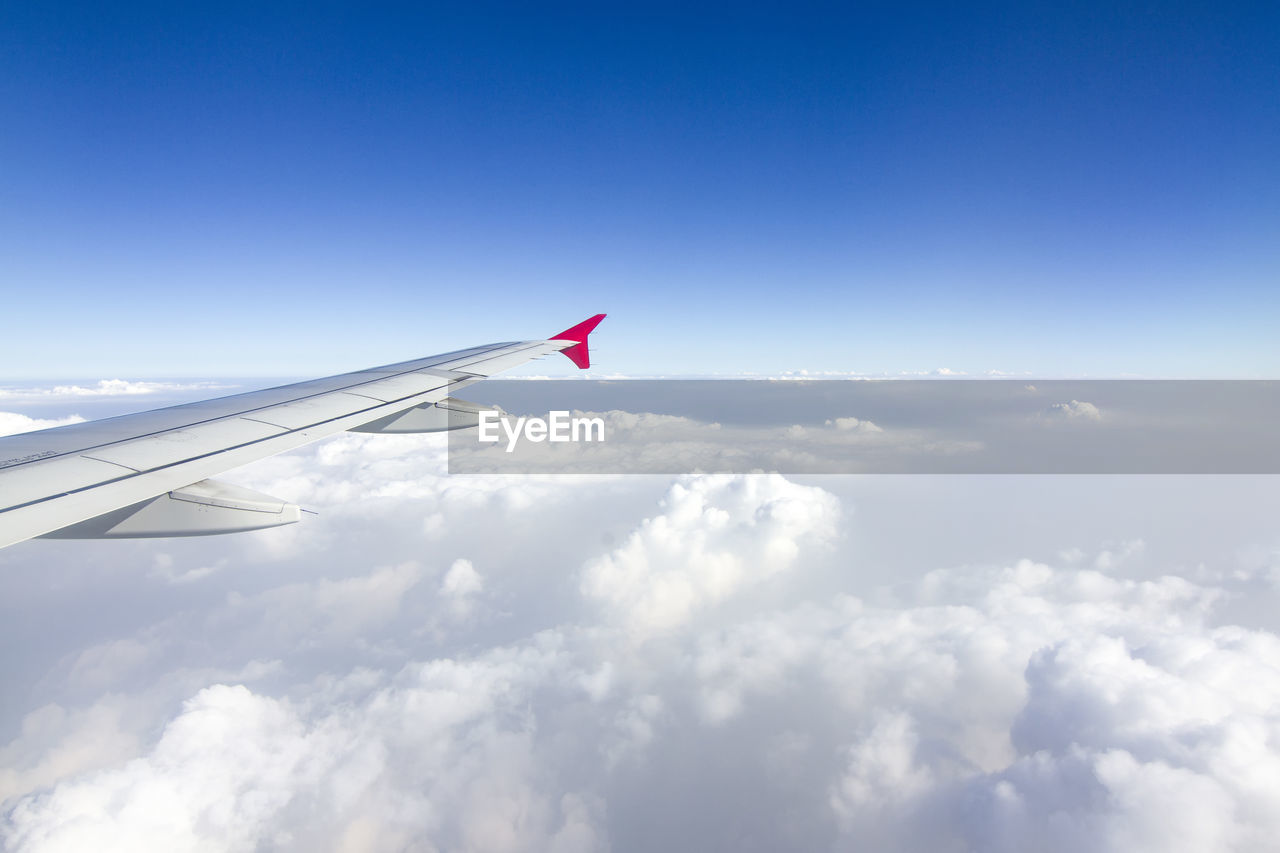 AIRPLANE WING AGAINST SKY