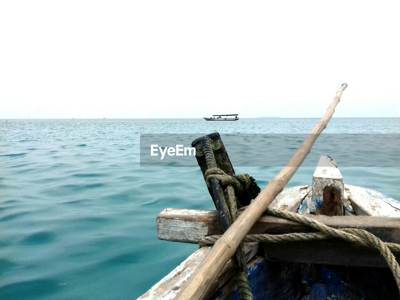 Cropped image of boat sailing on sea against clear sky