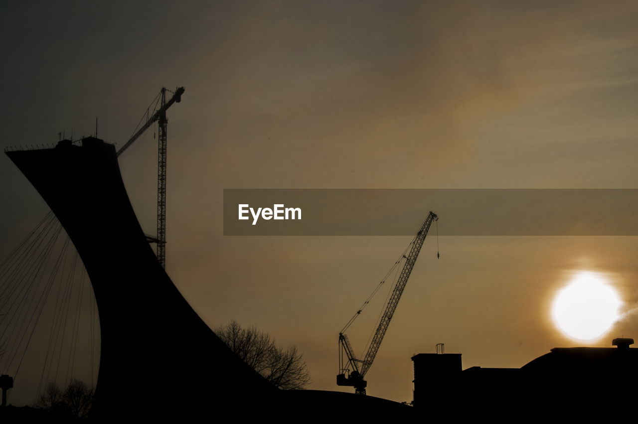 Low angle view of silhouette bridge against sky during sunset