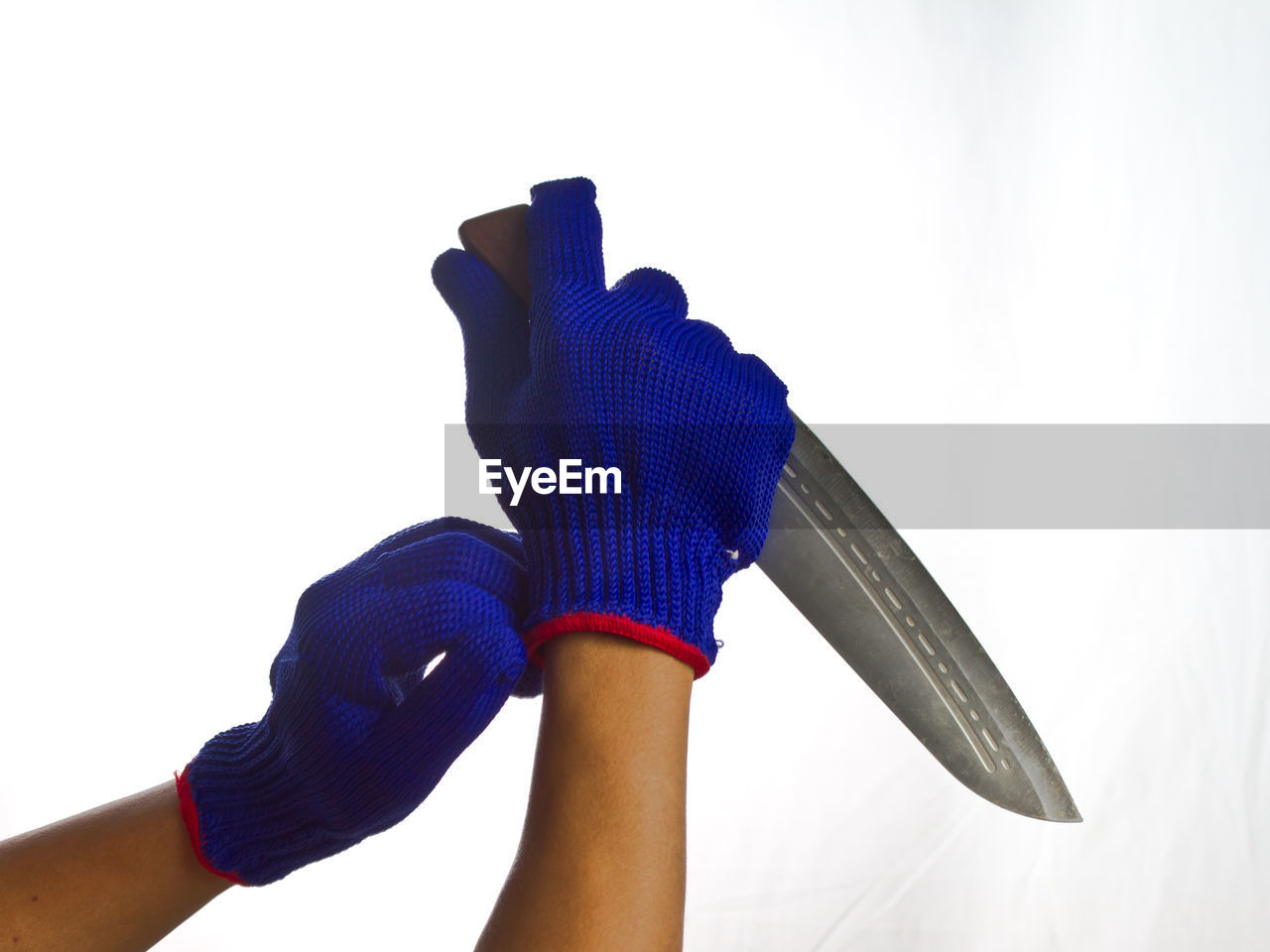 CLOSE-UP OF PERSON HOLDING BLUE UMBRELLA