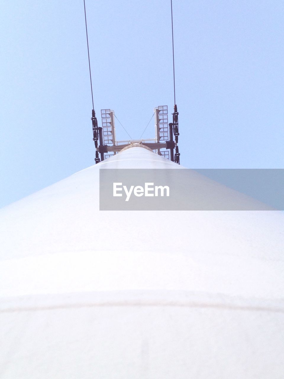 Directly below shot of overhead cable car column against clear sky