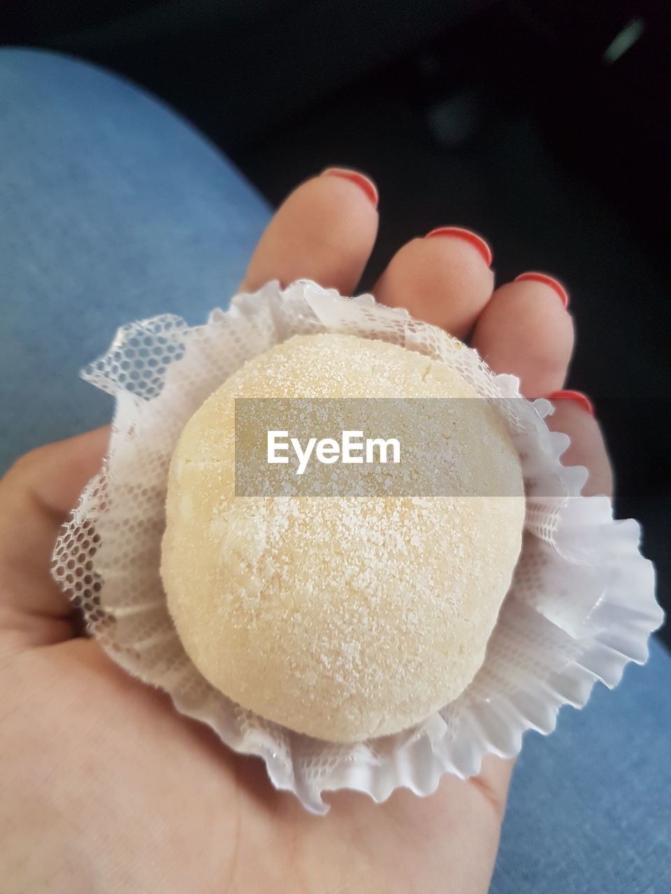 CLOSE-UP OF HAND HOLDING CUPCAKE