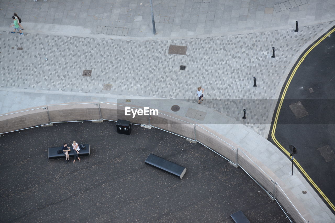 HIGH ANGLE VIEW OF PEOPLE WALKING ON A STREET