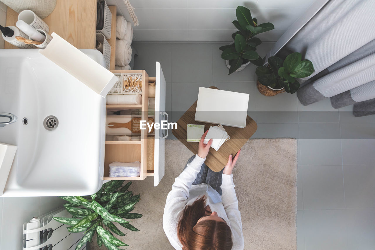 high angle view of woman standing in kitchen at home