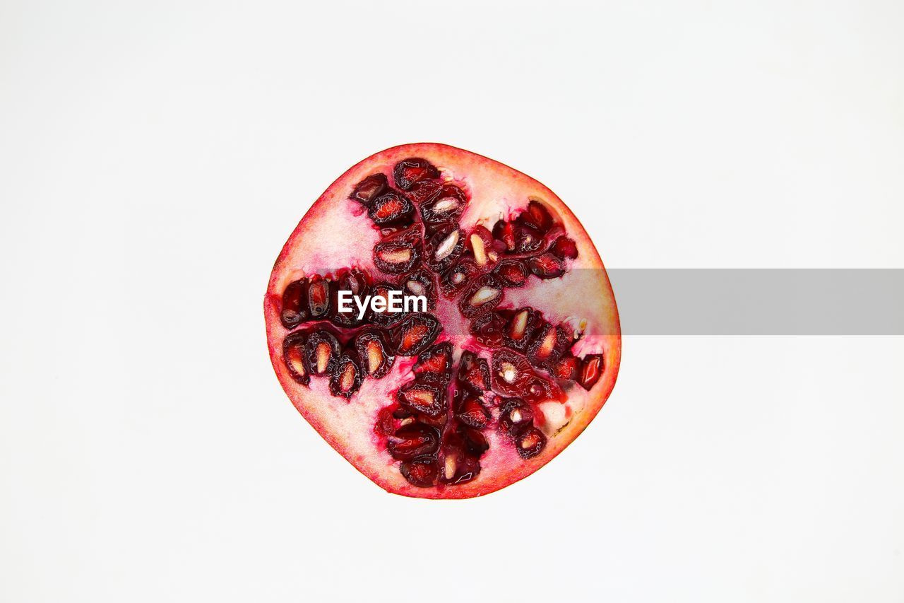 CLOSE-UP OF FRESH RED APPLE AGAINST WHITE BACKGROUND