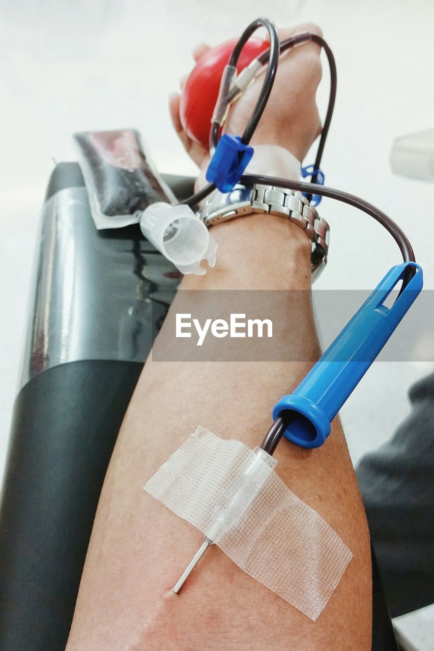 Close-up of needle in hand donating blood