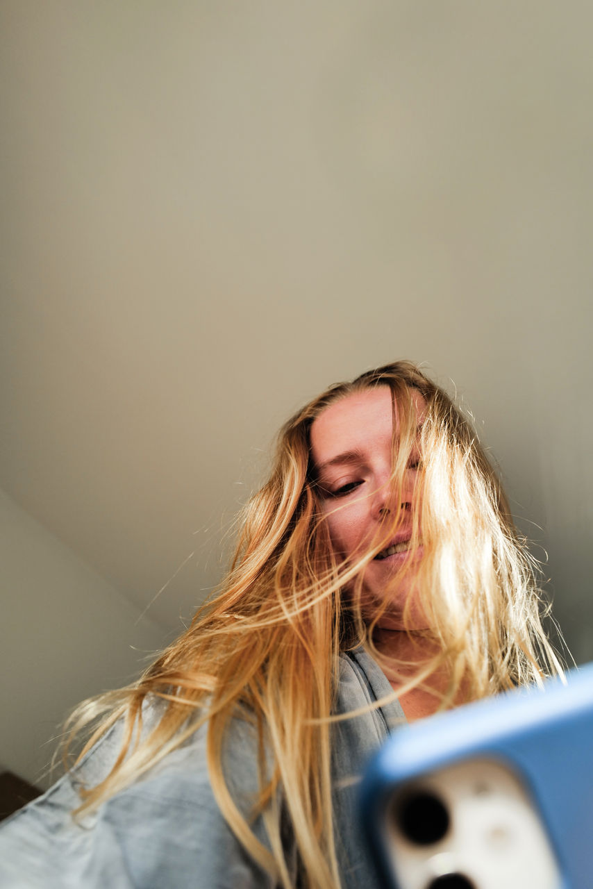 Low angle view on woman using her mobile phone