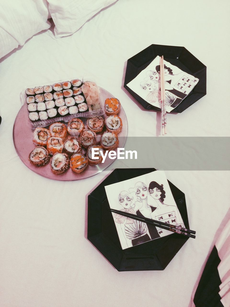 High angle view of sushi in plate with place setting on table