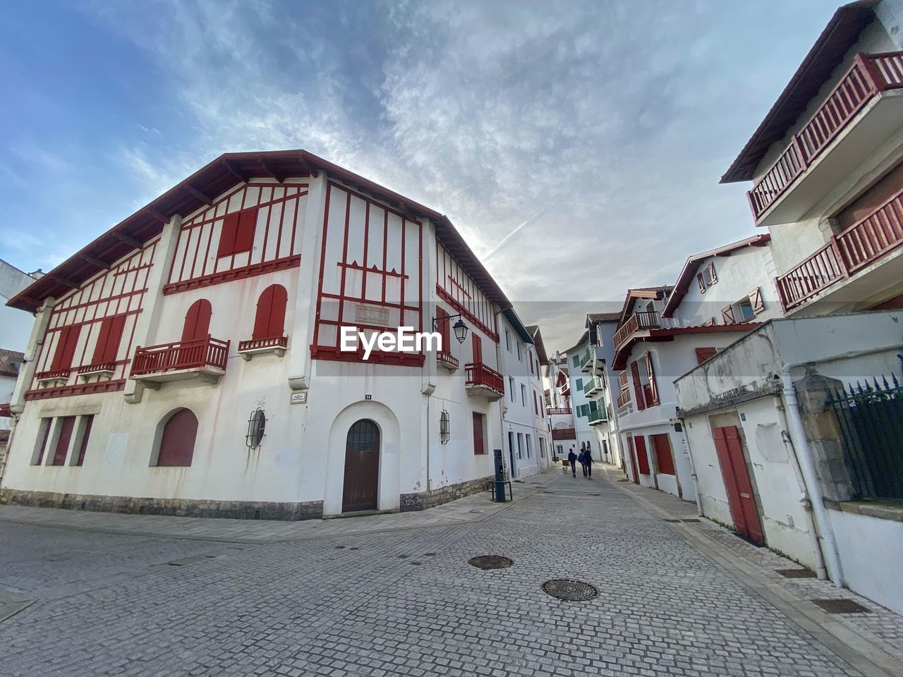 STREET AMIDST BUILDINGS AGAINST SKY