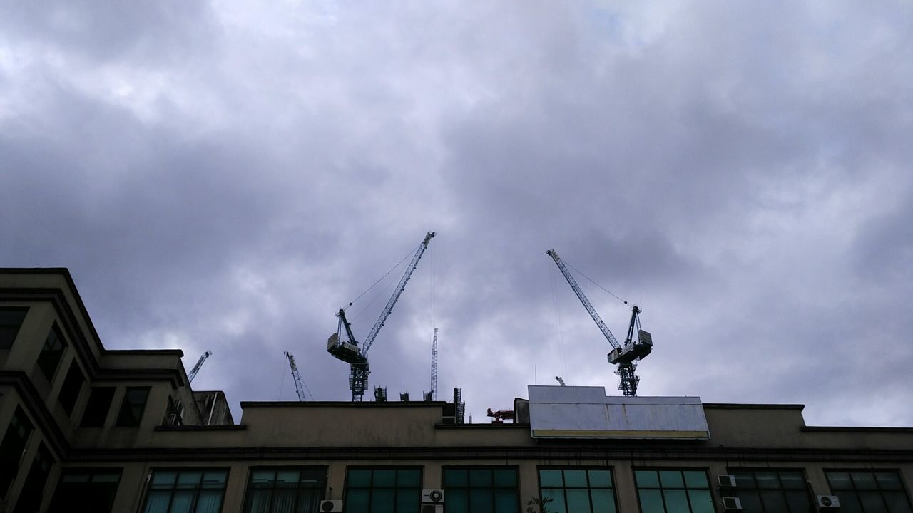 LOW ANGLE VIEW OF CLOUDY SKY OVER BUILDINGS