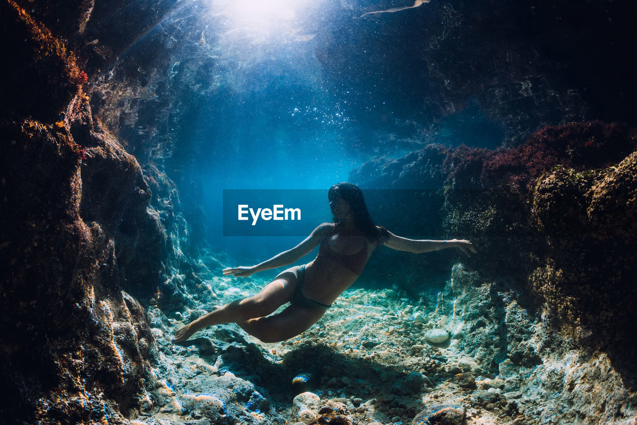 high angle view of woman swimming in sea