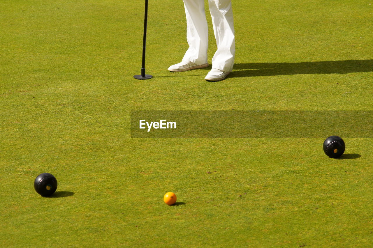 Low section of golfer playing on course