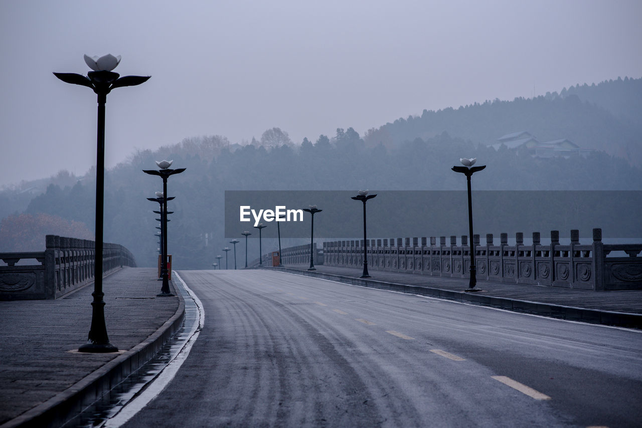 Street by road against sky during winter