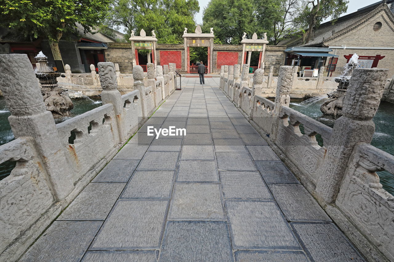 PANORAMIC VIEW OF STONE WALL AND TREES