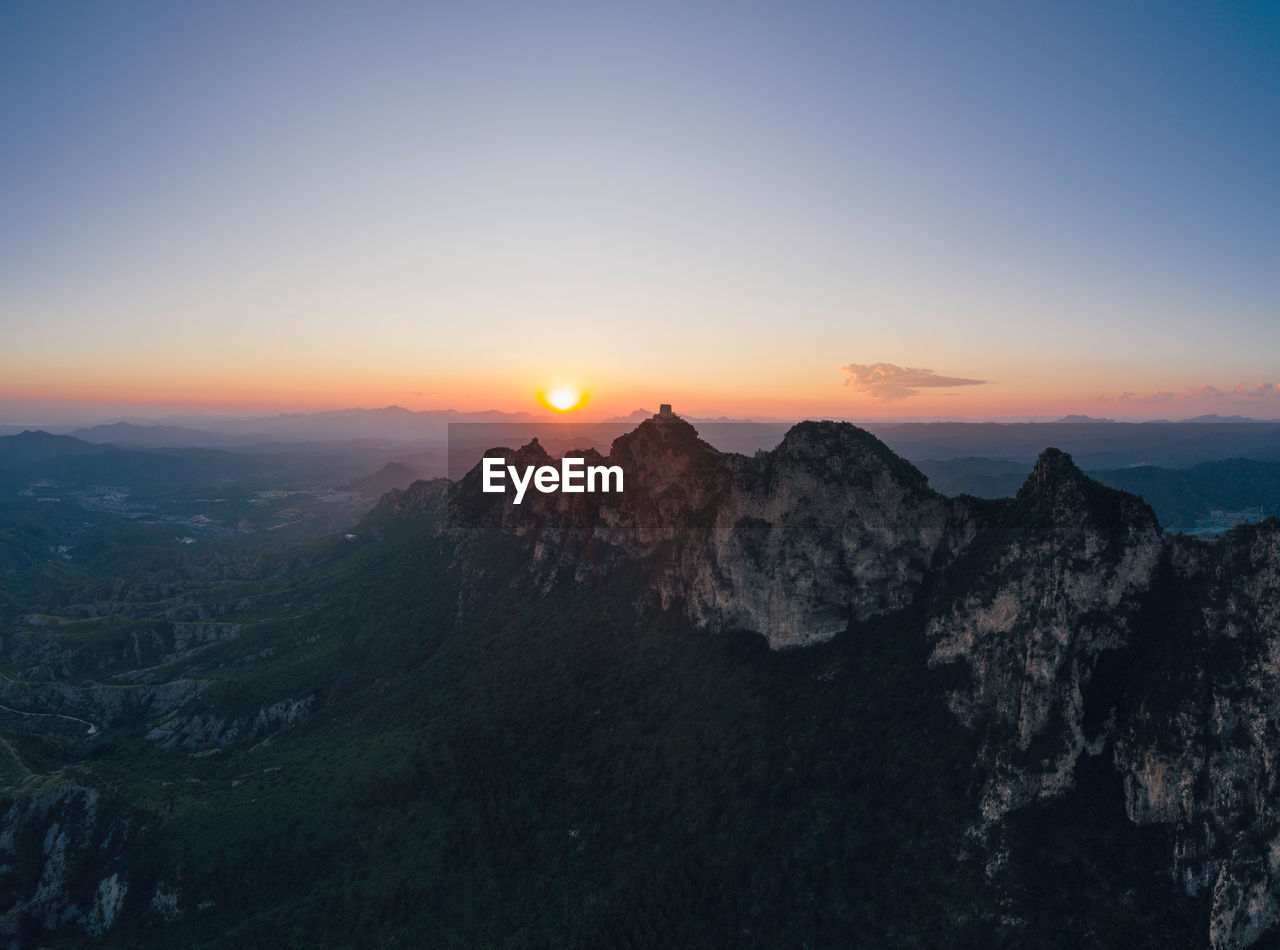 SCENIC VIEW OF MOUNTAINS DURING SUNSET