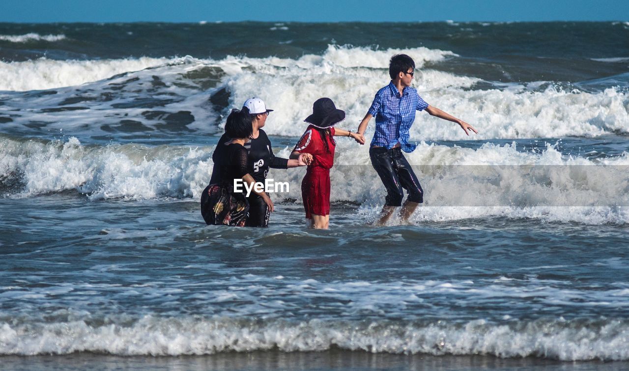 MAN SURFING ON SEA