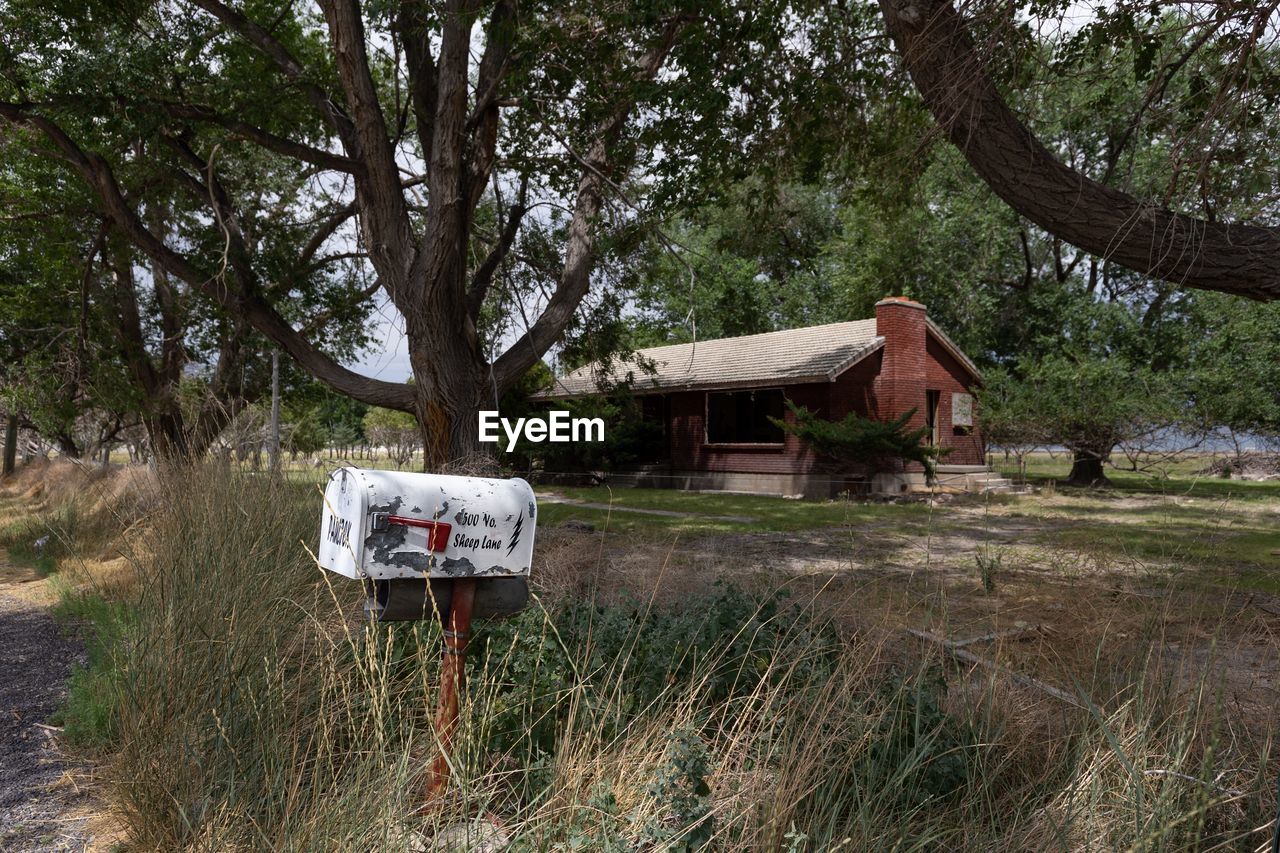 INFORMATION SIGN ON FIELD BY HOUSE