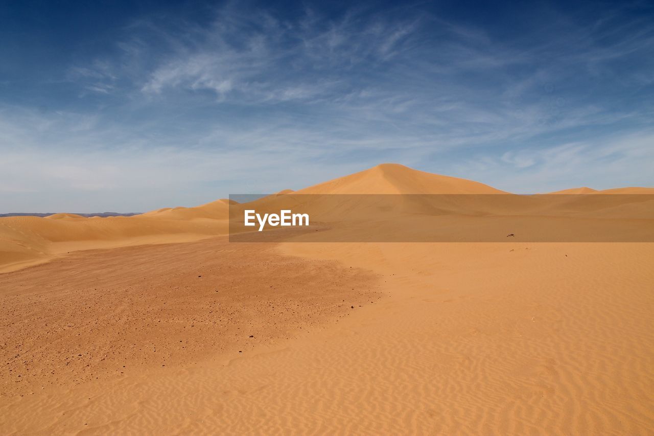 Scenic view of sahara desert against blue sky