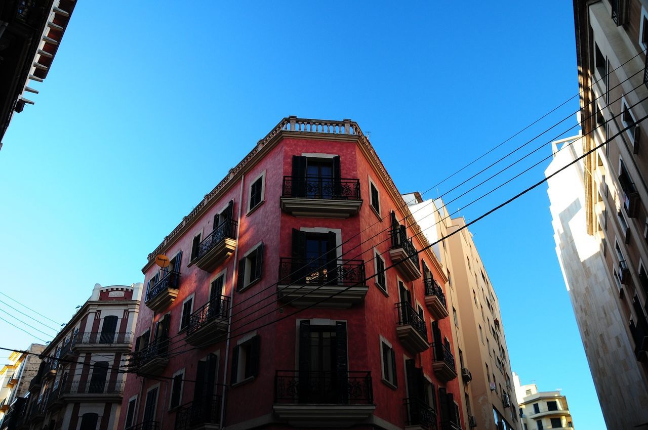 Low angle view of buildings against blue sky