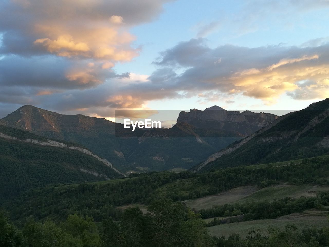 SCENIC VIEW OF MOUNTAINS AT SUNSET