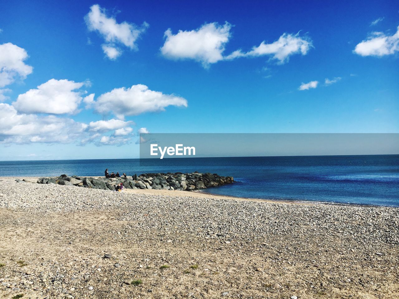 Scenic view of beach against blue sky