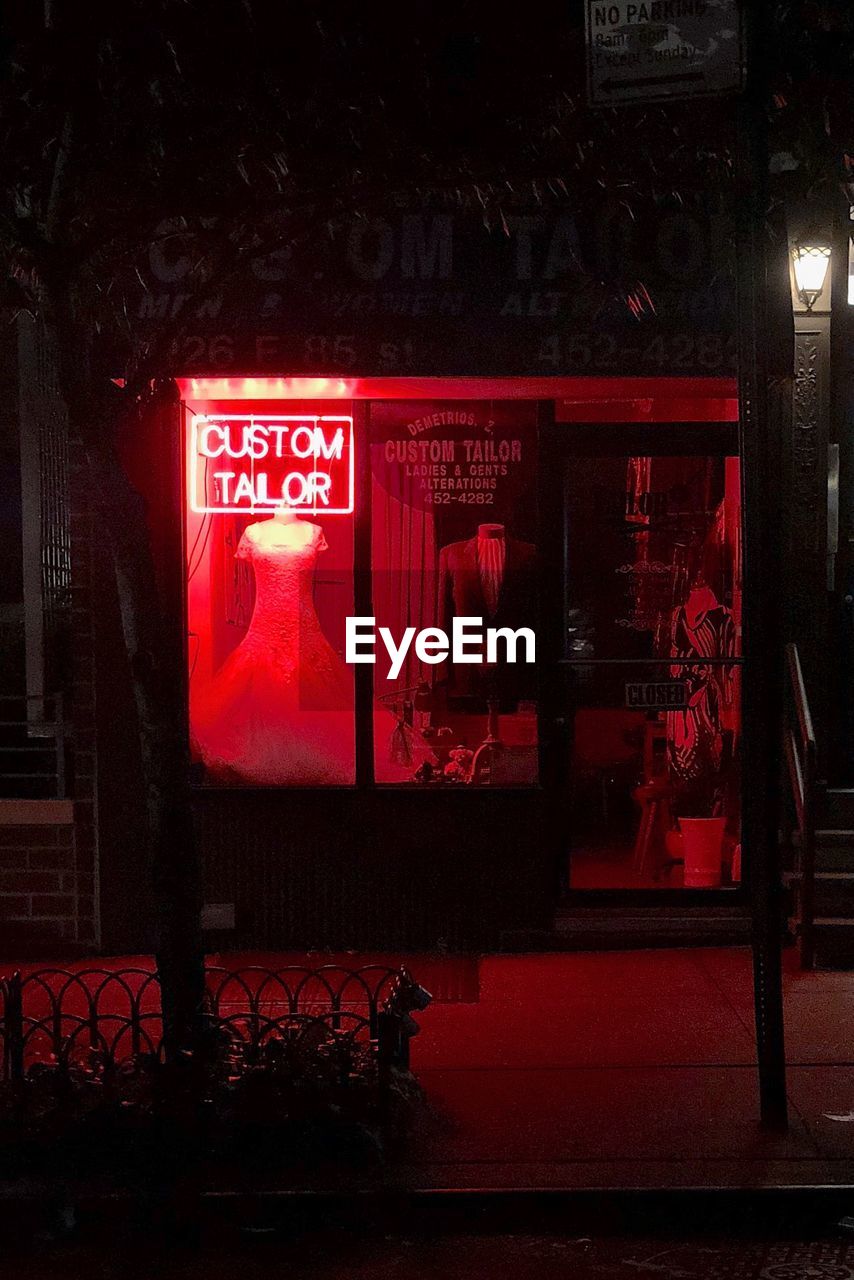 RED INFORMATION SIGN AT NIGHT