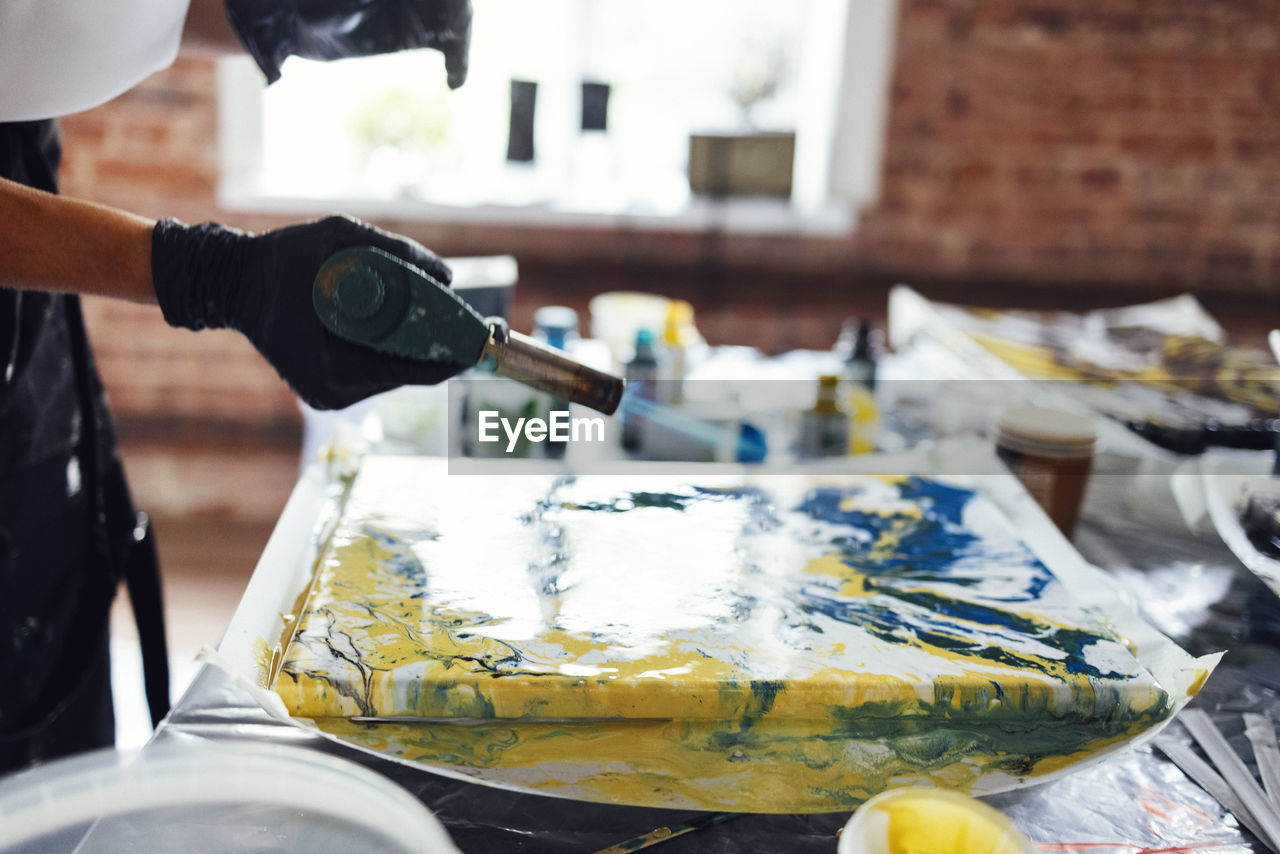 cropped hand of man working at table