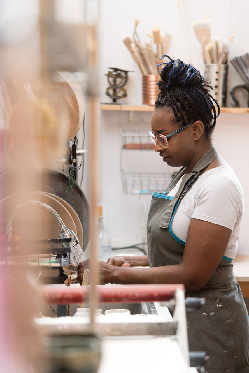 Woman washing dishes at the kitchen