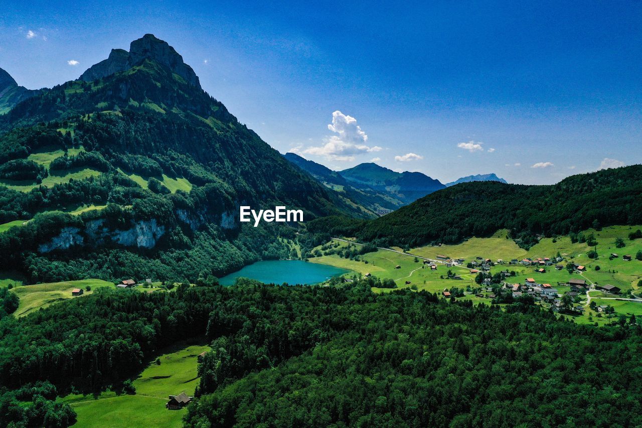 Scenic view of lake and mountains against sky