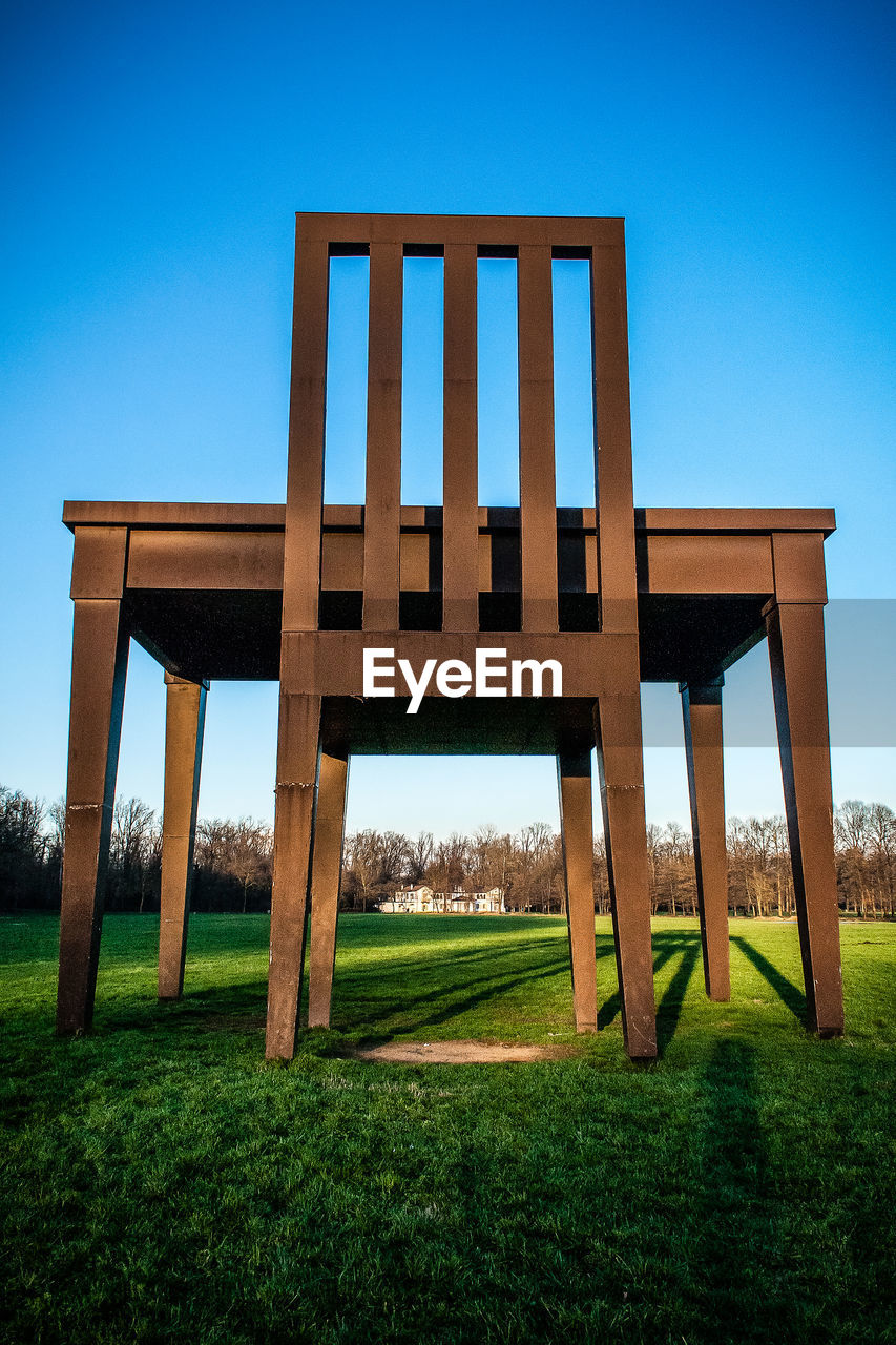 STRUCTURE ON FIELD AGAINST CLEAR BLUE SKY