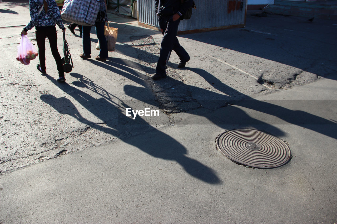 Low section of people walking on road