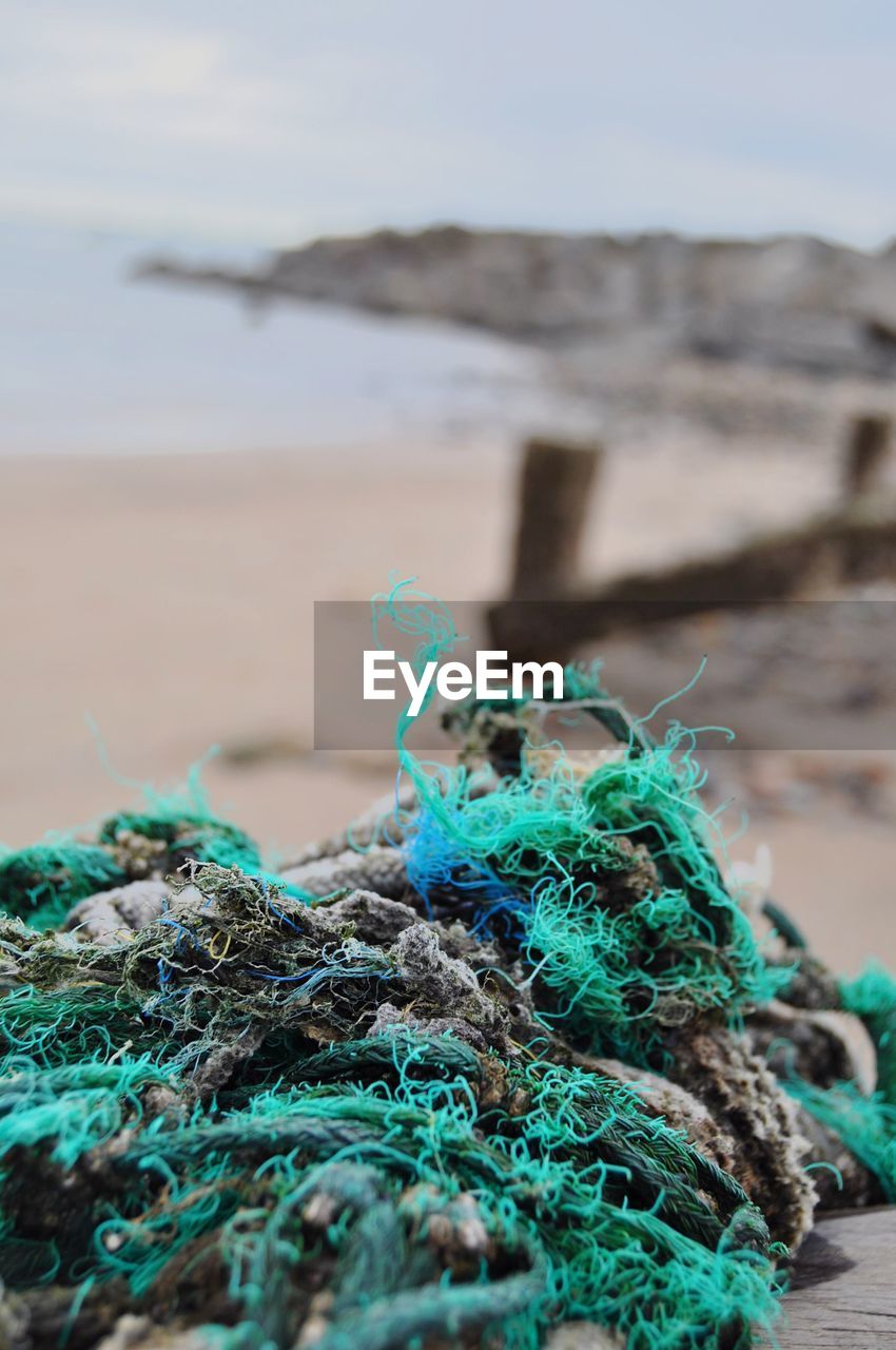 Close-up of fishing net on beach