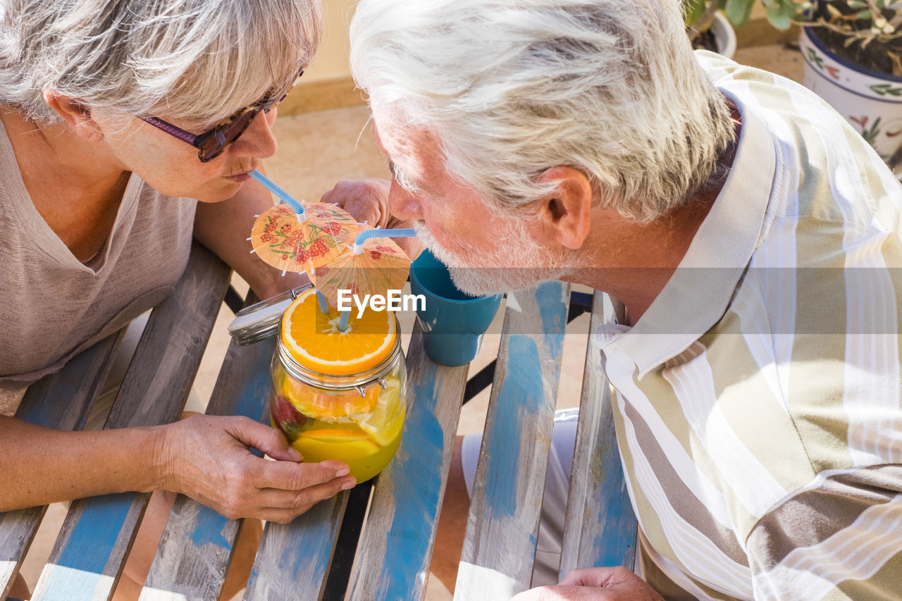 Senior couple enjoying wine at outdoors restaurant